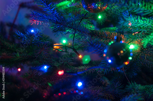 Merry Christmas and Happy New year Holidays! Macro or close picture of xmas tree and bulbs. Selective focus.