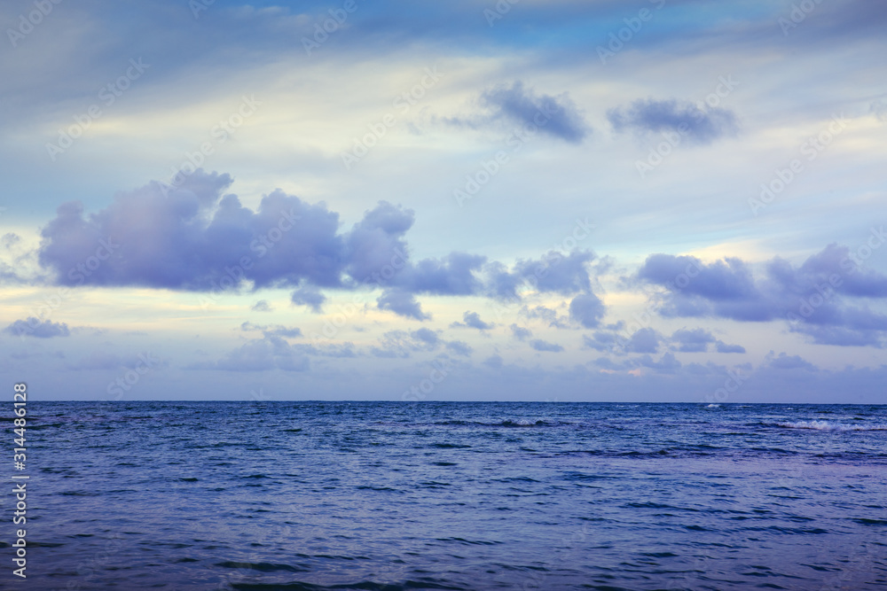 Obraz premium Caribbean sea and blue clouds sky. Travel background.