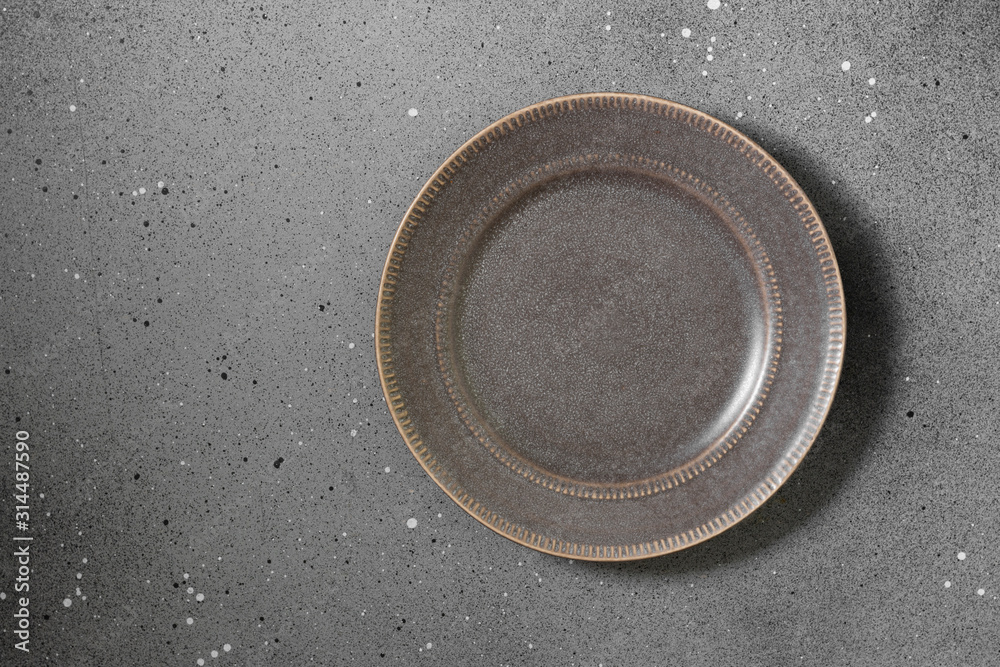 Grey plate on a grey background Grey plate on a grey background