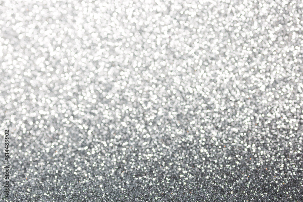 Metallic foil background. Shiny metal silver foil texture abstract defocused background. Sparkle glitter texture with bokeh lights