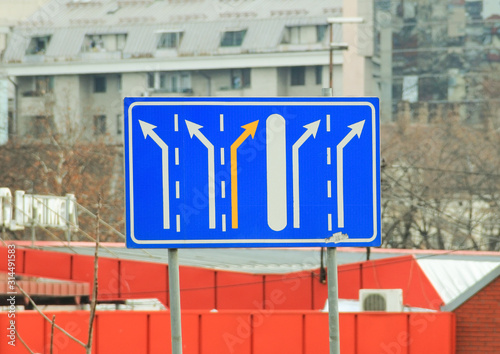 A street sign on blue background showing possible directions in the city.