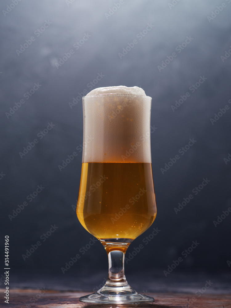 Glass of beer lager on a dark background