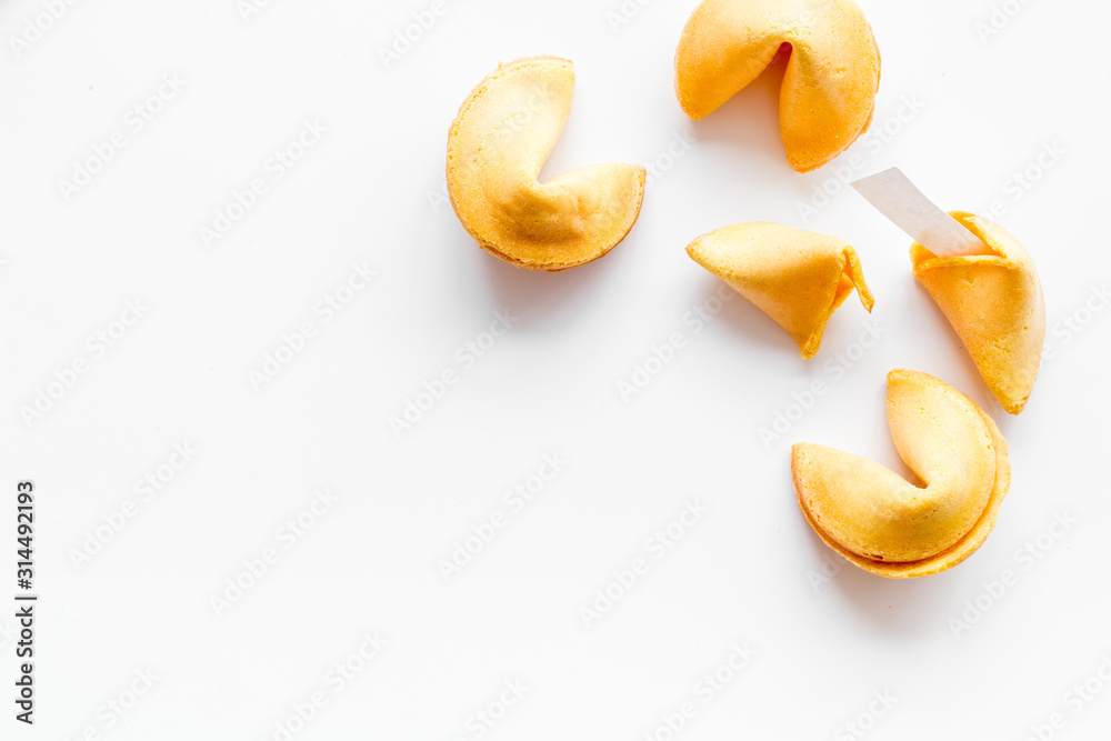 Traditional fortune cookies on white table top-down copy space