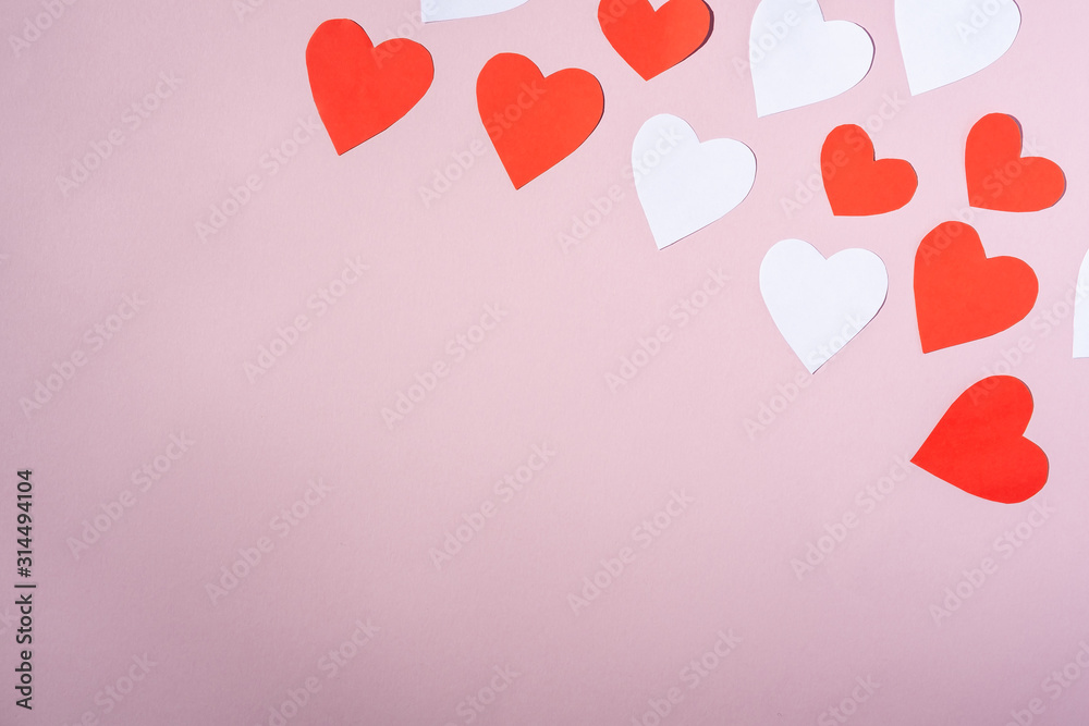 Red and white handmade paper hearts valentines on pink background, copy space, top view