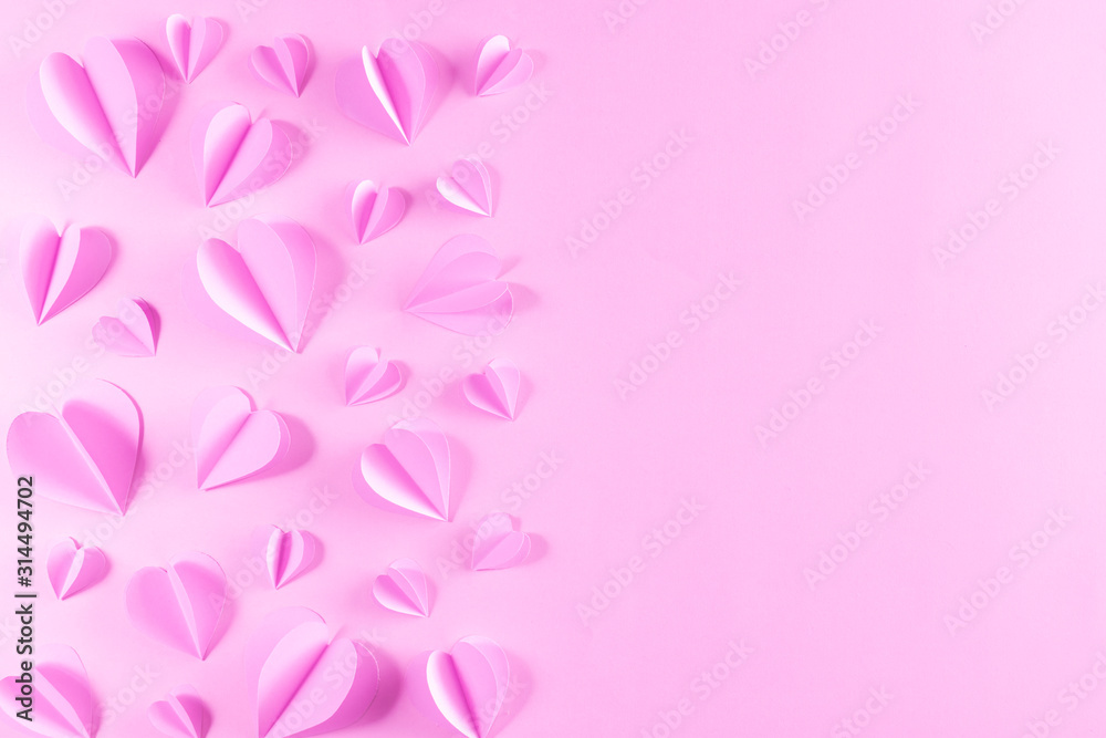 Pink hearts on pastel pink paper background. Background for Valentines day Mother's day, Women's day.