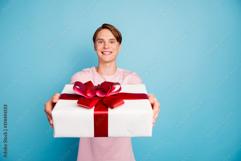 Portrait of positive cheerful guy lover date with girlfriend give her big white package gift box wear casual style outfit isolated over blue color background Portrait of positive cheerful guy lover date with girlfriend give her big white package gift box wear casual style outfit isolated over blue color background
