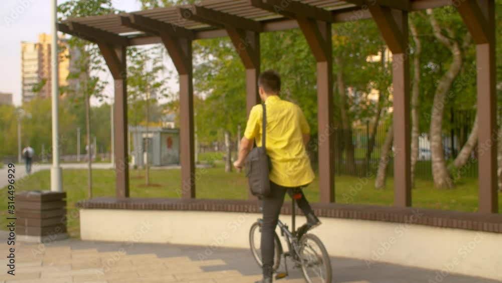 Man in yellow shirt working in the park Man in yellow shirt working in the park
