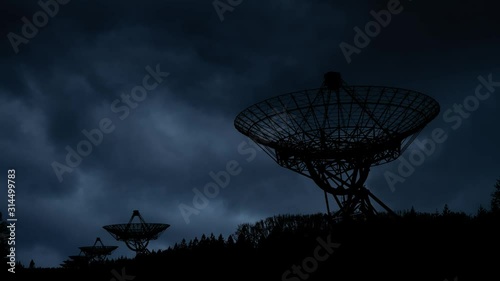 Westerbork Synthesis Radio Telescope with Lightning and Thunderstorm Flash over the night sky photo