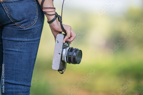 young hipster girl photographer with film camera 