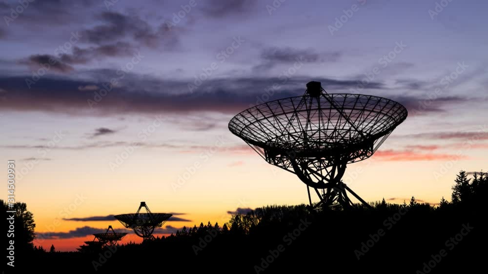 Radio Telescope Westerbork (WSRT): Time Lapse at Twilight with Colourful Sky and Dark Silhouette of Antennas, Netherlands Radio Telescope Westerbork (WSRT): Time Lapse at Twilight with Colourful Sky and Dark Silhouette of Antennas, Netherlands