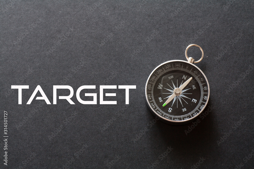 Target word written on black background with compass Target word written on black background with compass