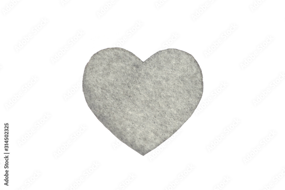 Оne gray felt heart on a white isolated background. Stock photo for the day of St. Valentine with empty space for your text. For web, print, postcards and wallpaper.
