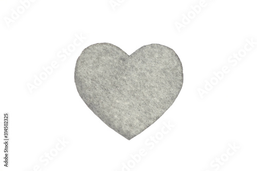 Оne gray felt heart on a white isolated background. Stock photo for the day of St. Valentine with empty space for your text. For web, print, postcards and wallpaper.