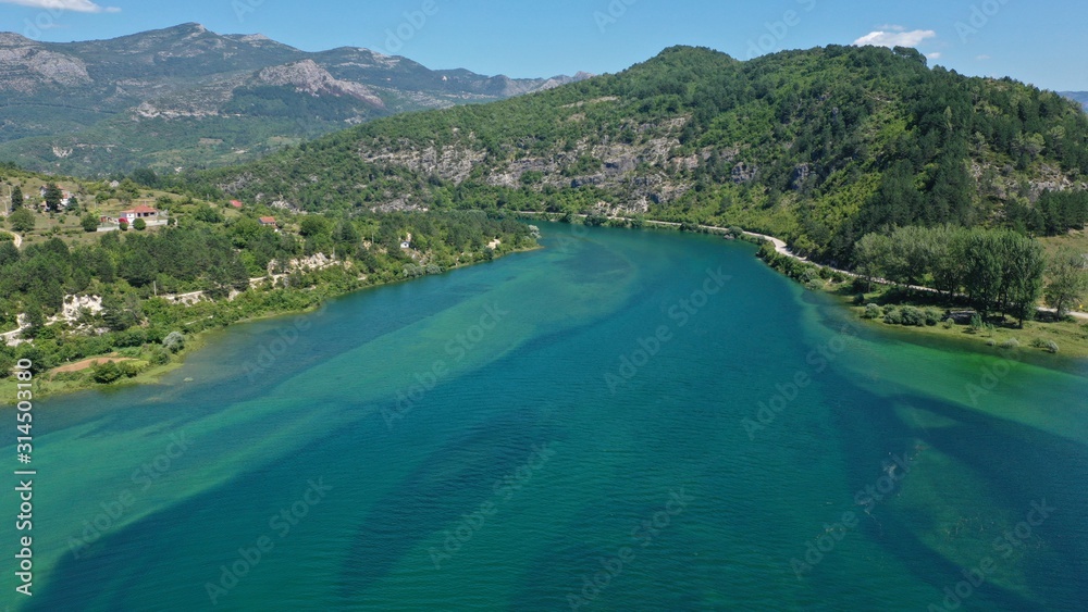Fototapeta premium Aerial view of Trebisnjica river mountainous valley, Lastva village, Bosnia and Herzegovina. Turquoise water, green hills.