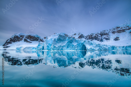 Picturesque reflection of a glacier in sea water