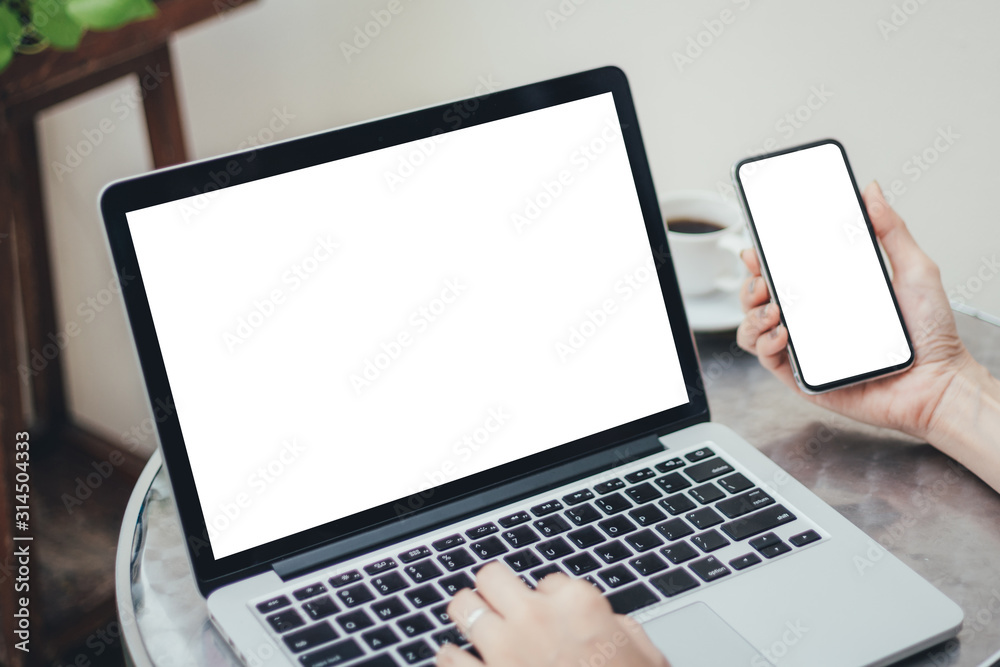 mockup image blank screen computer,cell phone with white background for advertising text,hand man using laptop texting mobile contact business search information on desk in office.marketing,design mockup image blank screen computer,cell phone with white background for advertising text,hand man using laptop texting mobile contact business search information on desk in office.marketing,design
