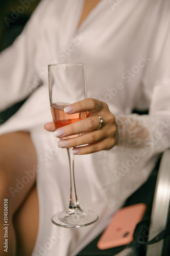 a glass of champagne in the hands of the bride