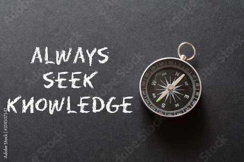 Motivational and Inspritation quote : Knowledge concept ,on black background with compass photo