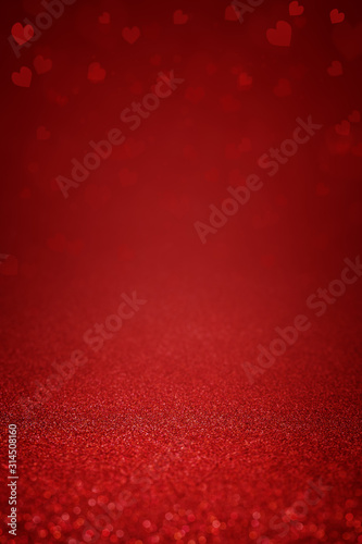 Sparkling deep red glitter background with hearts. Abstract background for Valentine's Day, love and romantic celebration. Festive banner and poster. Copy space for text.