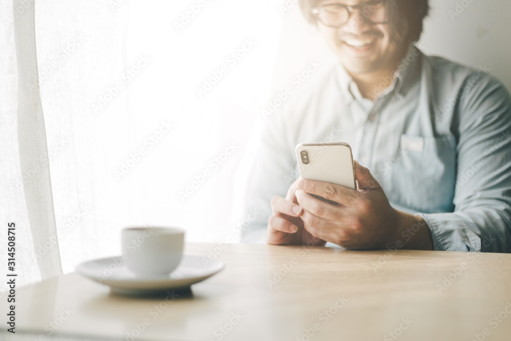 using cell phone.portrait young asian man wear eye glasses Smiling cheerful look screen texting chatting on mobile.contact connecting people freedom life style concept using cell phone.portrait young asian man wear eye glasses Smiling cheerful look screen texting chatting on mobile.contact connecting people freedom life style concept