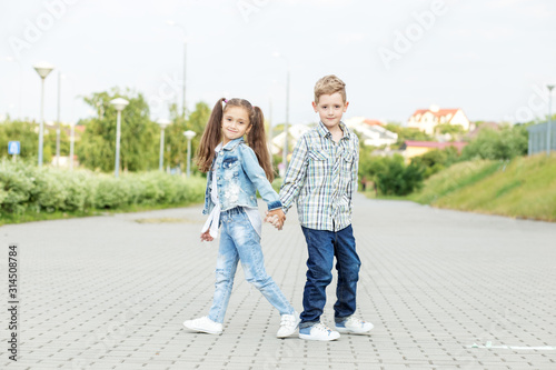 Children walk holding hands. The concept of childhood, back to school, friendship. © Olha Tsiplyar