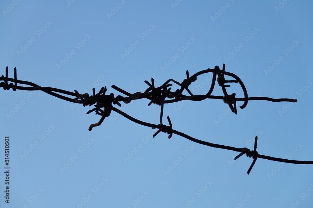 Wire fence against blue sky Wire fence against blue sky