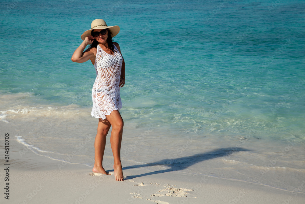 Tropical vacation concept. Girl in a dress on the background of the ocean Tropical vacation concept. Girl in a dress on the background of the ocean