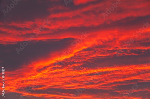 Gloomy sky after the rain in sunlight at sunset, Sky After sunset -Red background © evgenii