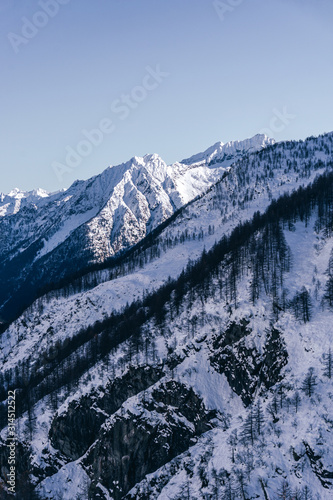 The snowy mountains of the Anzasca valley, near Monte Rosa, during a sunny winter day, near the town of Macugnaga, Italy- December 2019.