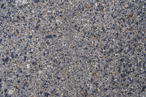 A background picture of a normal asphalt surface during a day time .