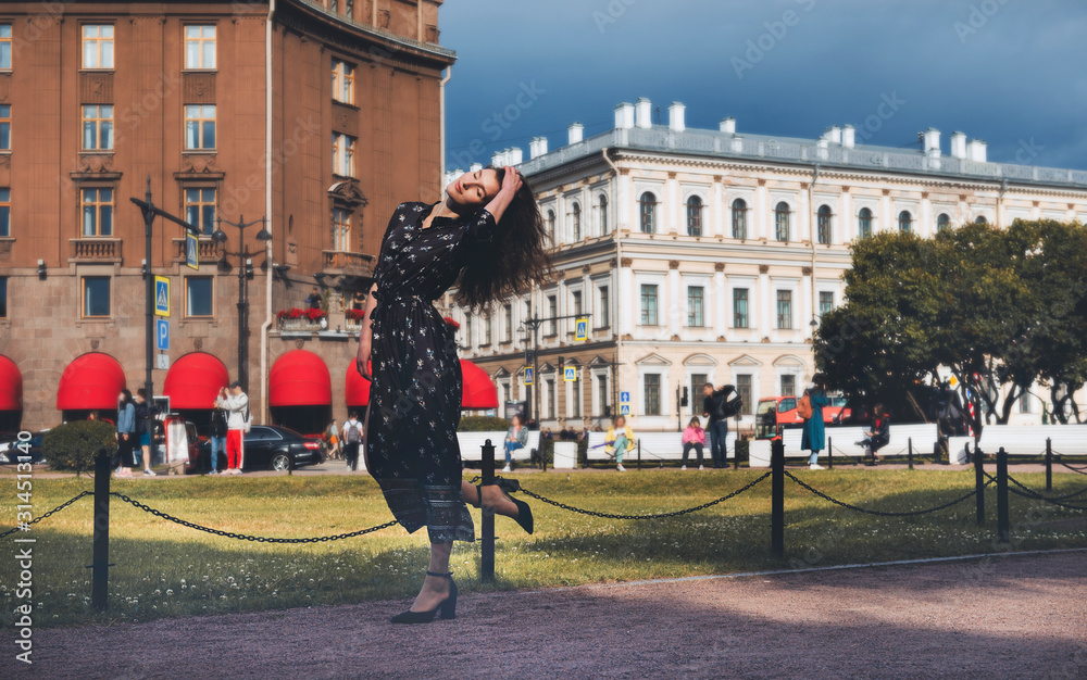 1 white young woman in a long dress in the city on a Sunny day, St. Petersburg