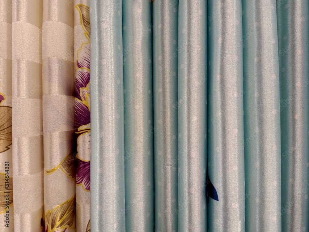the background of the textile pattern of blue and brown curtains for sale in the local store of Thailand the background of the textile pattern of blue and brown curtains for sale in the local store of Thailand