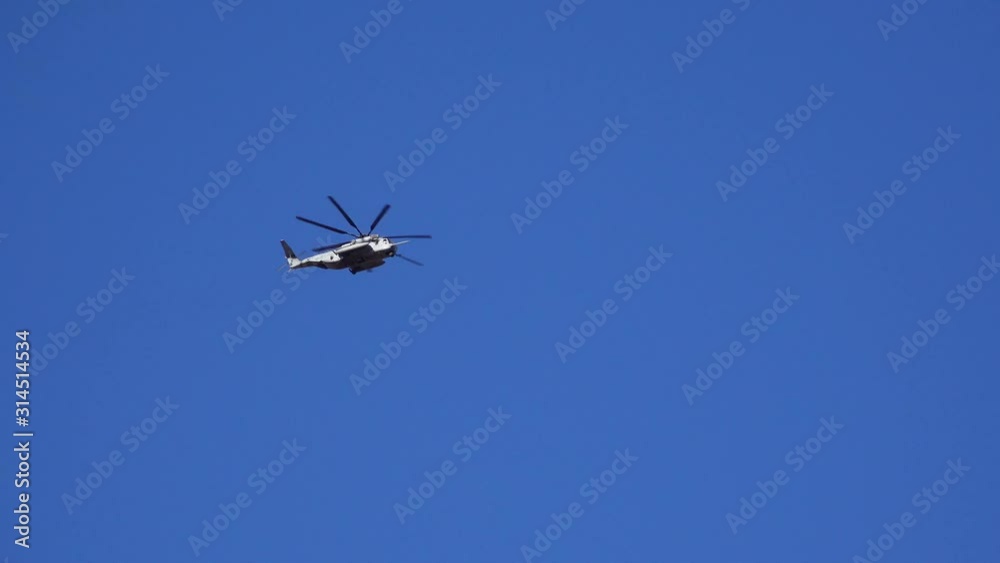 CALIFORNIA, USA - NOVEMBER 26, 2019: A helicopter against the blue sky in the Arizona desert. CALIFORNIA, USA - NOVEMBER 26, 2019: A helicopter against the blue sky in the Arizona desert.