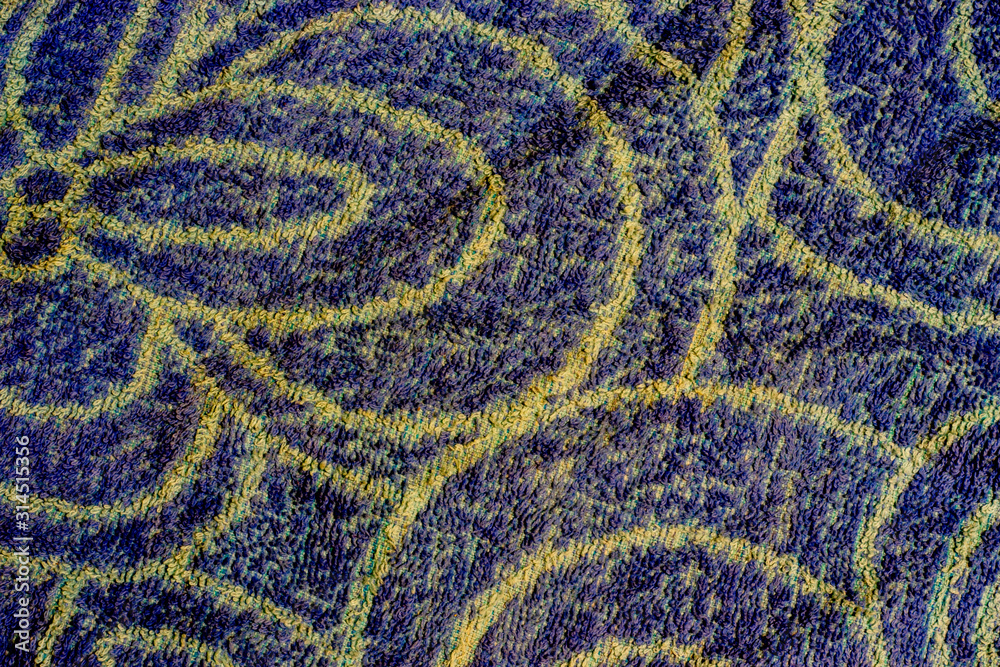 Blue woven texture with yellow patterns. Background with copy space