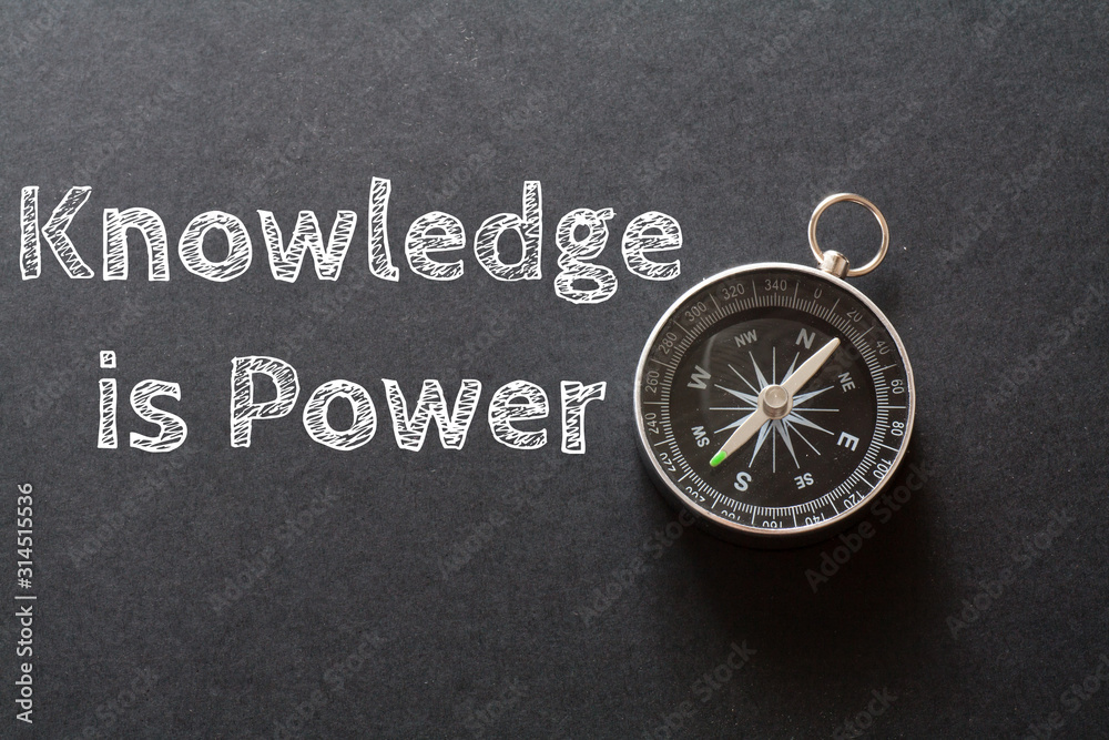Written Knowledge Is Power words on black background with compass Written Knowledge Is Power words on black background with compass