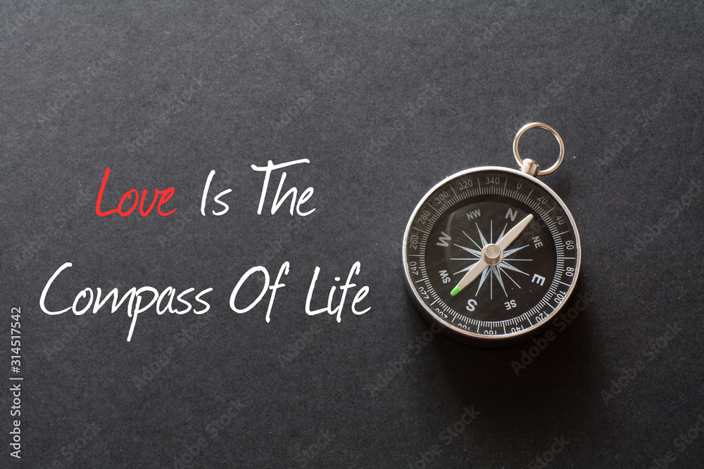 Inspirational quote : Love is the compass of life ,on black background with compass Inspirational quote : Love is the compass of life ,on black background with compass