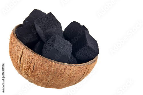 Coconut charcoal on a white background. Coconut coal cubes for hookah and coconut close-up. Side view.
