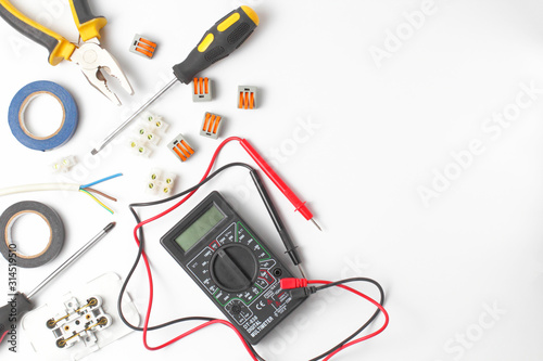 Quadro su tela Electrician tools and instruments on a white background, flat lay, close-up, place for text