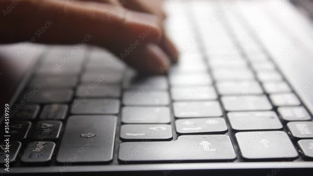 hands typing on laptop keyboard