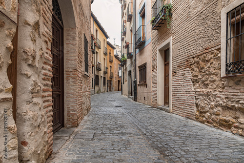 View of a narrow street in the old town of Segovia, Spain. Old style of construction still used in this part of Spain