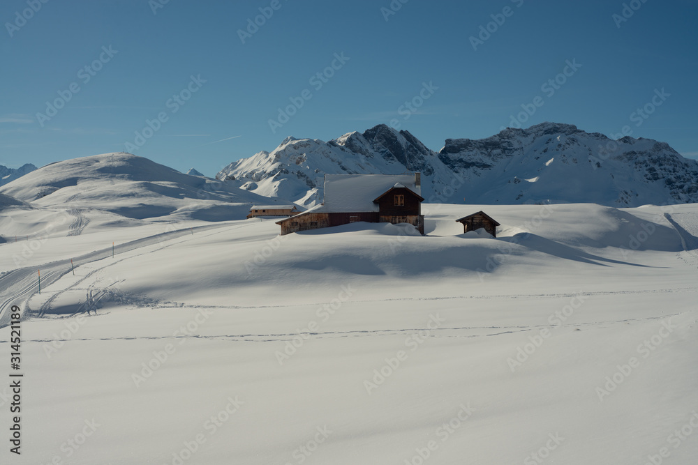 Old house in alpine winter landscape