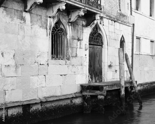 A black and white photo of a water gate, Venice, Italy