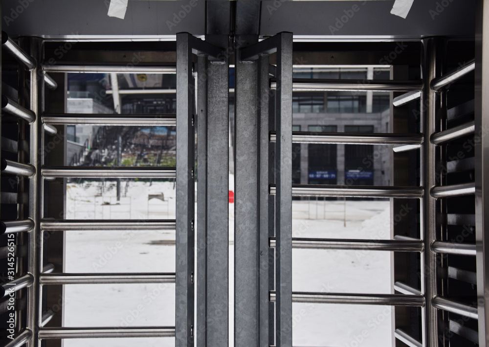 Full-height metal turnstiles in the stadium.