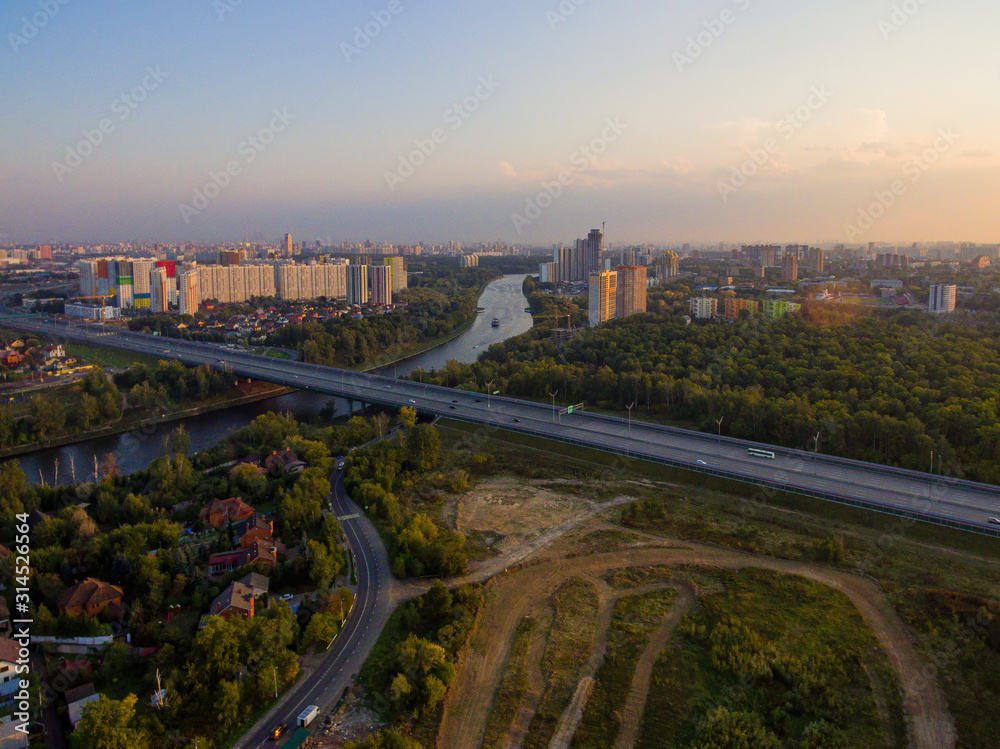  Summer landscape with a bird's-eye view of the city and the motorway.