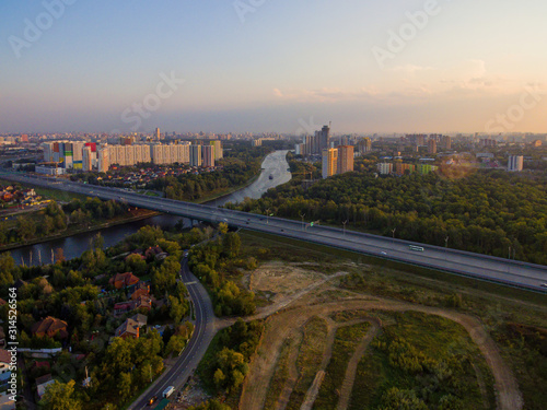  Summer landscape with a bird's-eye view of the city and the motorway.