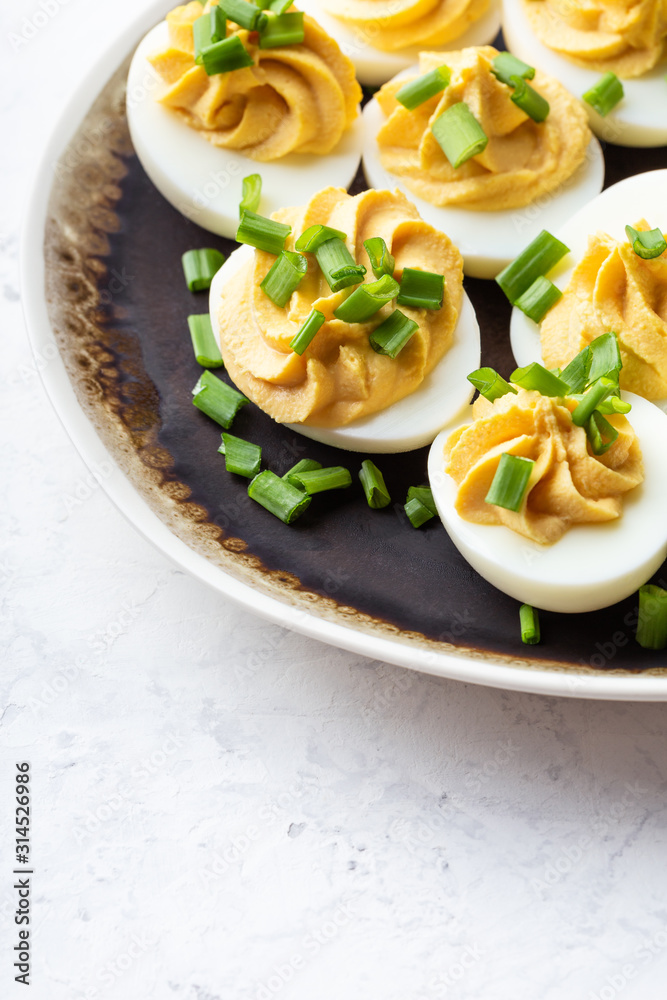 Deviled eggs in rustic ceramic plate