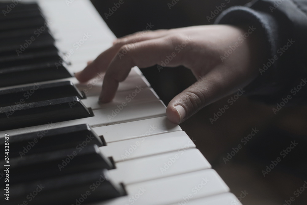 Fototapeta premium children's hand on the piano