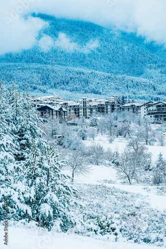 Mountain snow peak, Alpine village houses. Europe, old town winter ice hill top panoramic view.