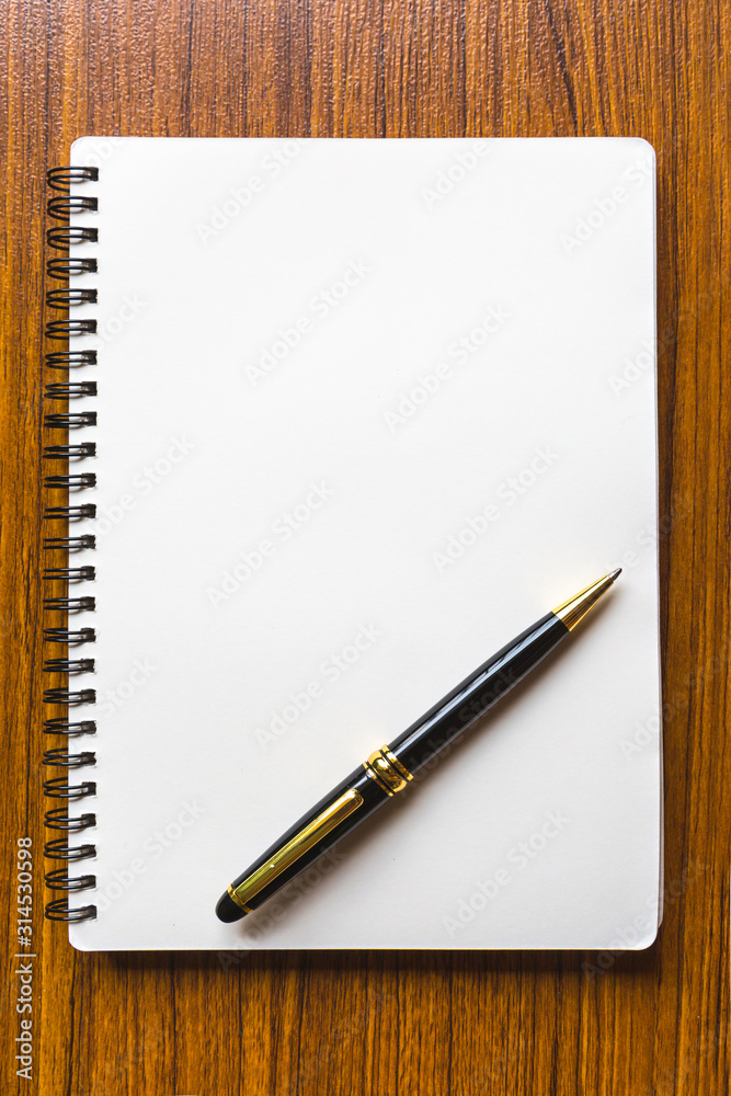 close up opening note paper and pen on wood texture background with copy space