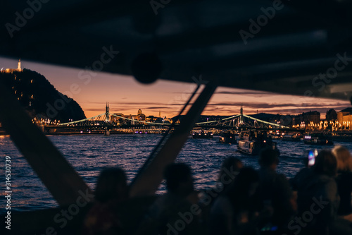 Photography People on the boat have a view of the evening city. bridges thro